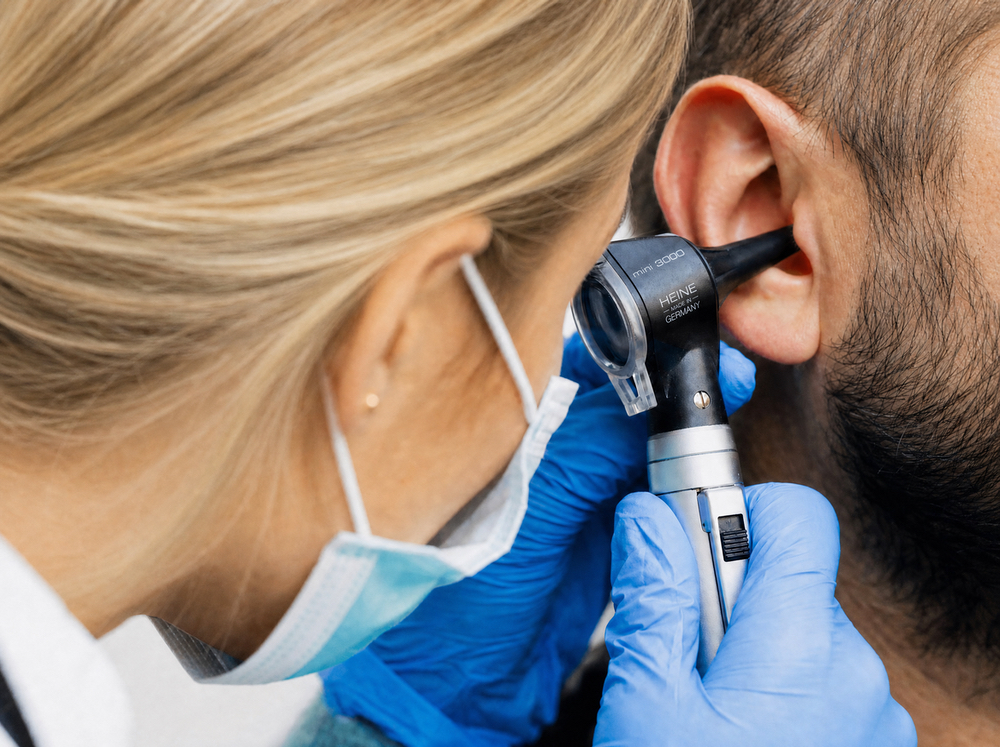 Otoscope examination of a patient's ear canal before earwax removal at Anne Arundel Audiology in Glen Burnie, MD