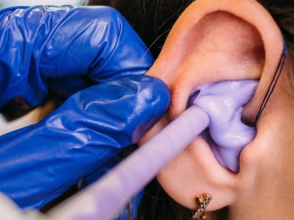 Dr. Britney Ometz, Au.D. taking a custom ear impression for hearing protection at Anne Arundel Audiology in Glen Burnie, MD