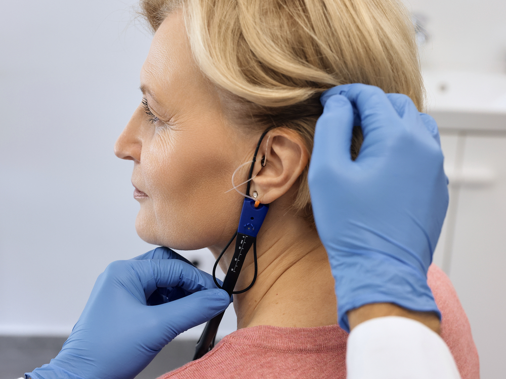 Dr. Britney Ometz, Au.D. performing real ear measurement on a hearing aid patient at Anne Arundel Audiology in Glen Burnie, MD
